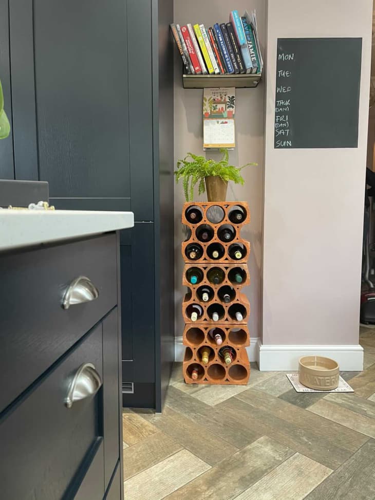 DIY pipes stacked on top of each other and used to hold wine bottles in a kitchen