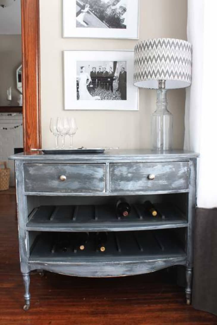 Vintage-style distressed painted dresser with bottom two drawers removed to hold wine bottles