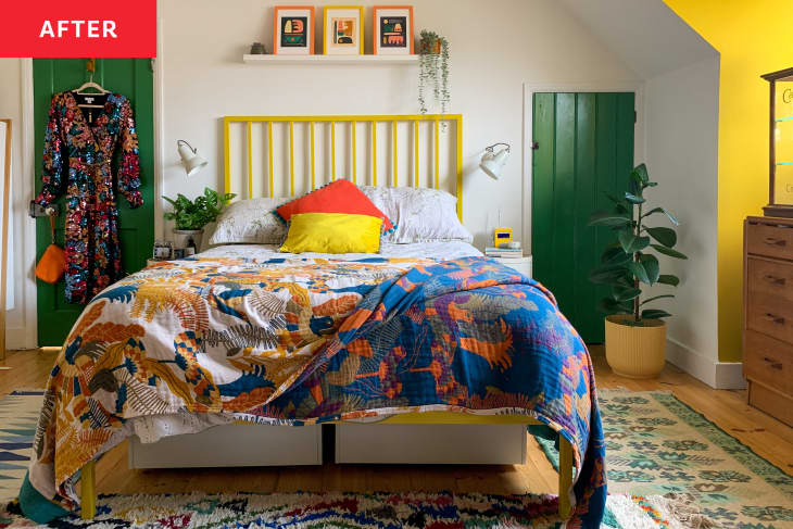 A bedroom with green and yellow accent walls with a colorful bed comforter.