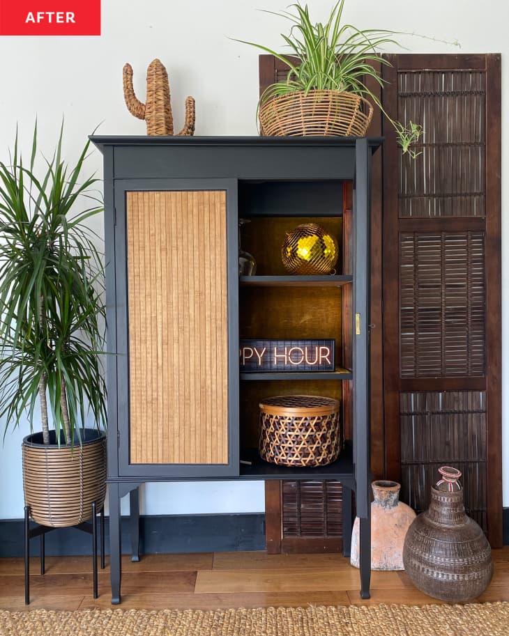 A black and brown cabinet with one door open