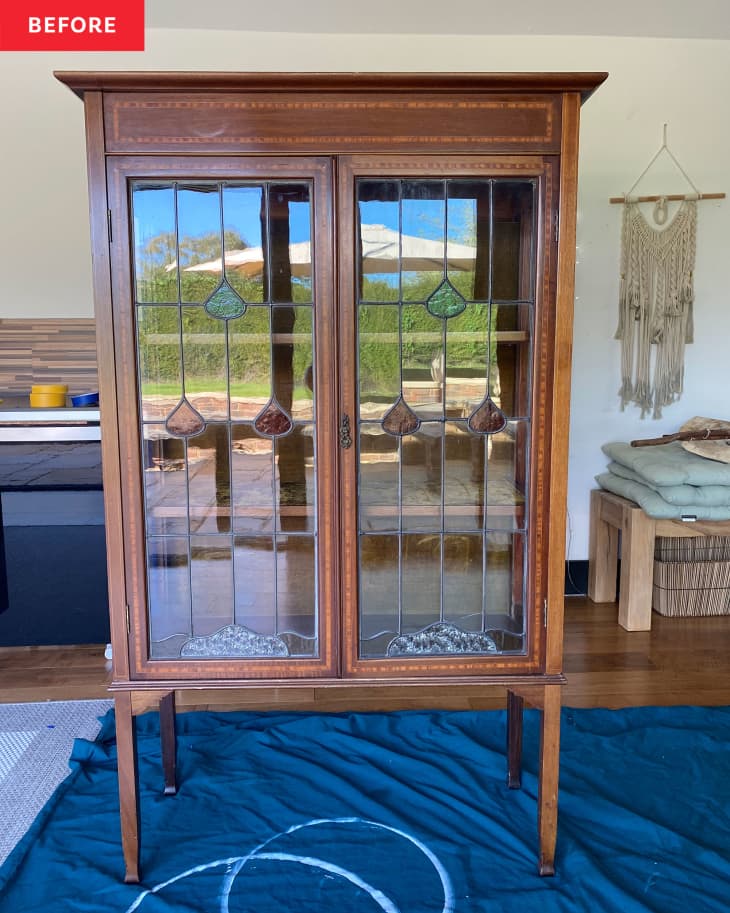 A brown cabinet with glass doors