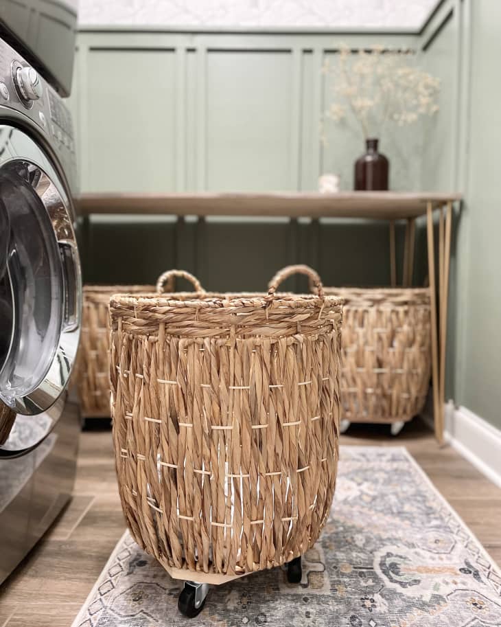 green laundry room with built in storage and natural storage baskets after remodel