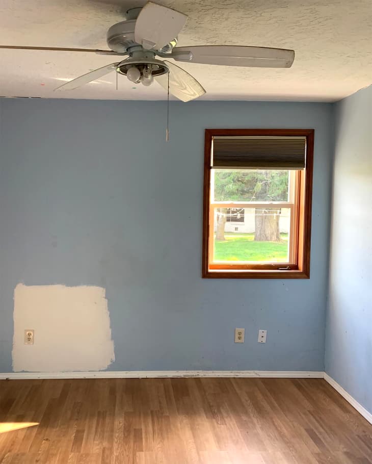 Blue painted bedroom before renovation.