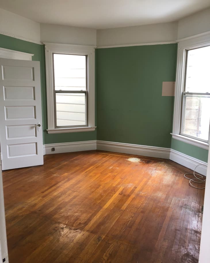 Green painted bedroom before renovation.