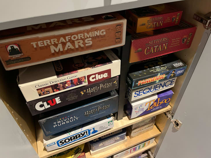 Boardgames organized in cabinets.