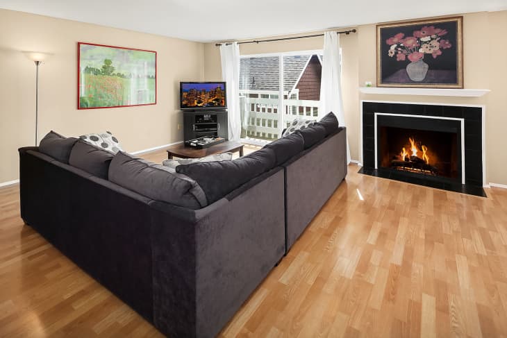 Fireplace in living room with section before renovation.