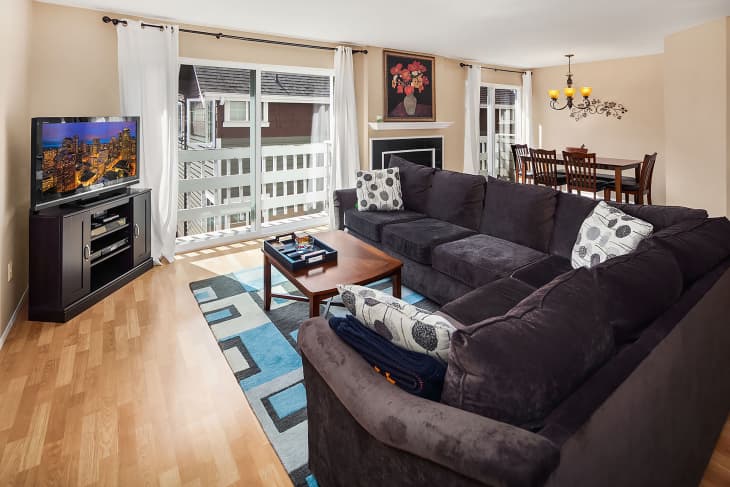 Grey sectional in living room before renovation.