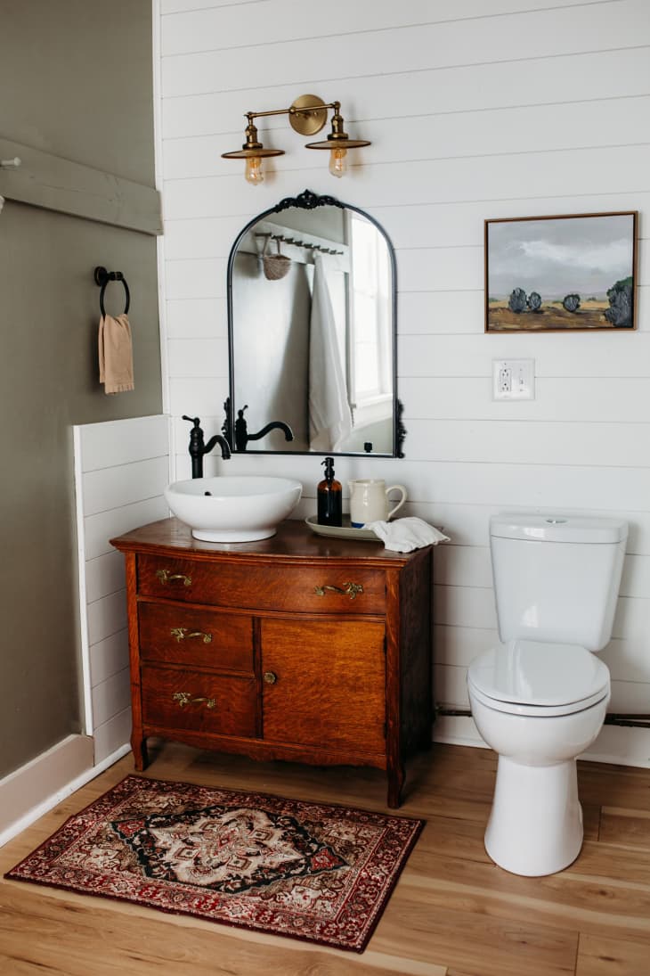 Vintage dresser turned vanity in bathroom after renovation.