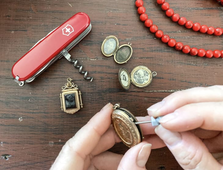Using a small Swiss Army Knife attachment to pry open a stuck locket