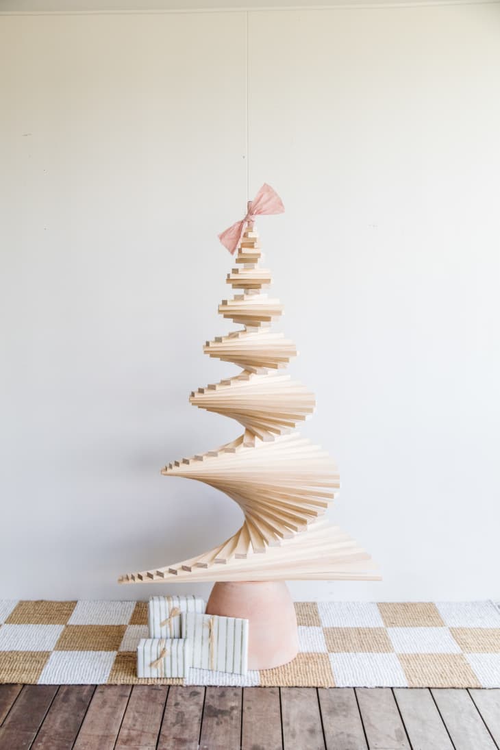 Christmas tree made with slatted wood pieces spun to create a swirling pattern.