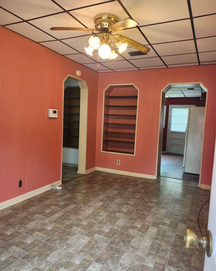 Pink painted walls in dated entryway before renovation.