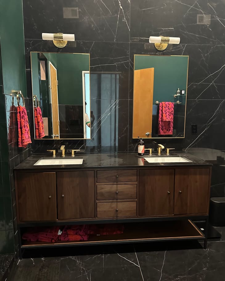 Black tiled wall in vanity area of newly renovated bathroom