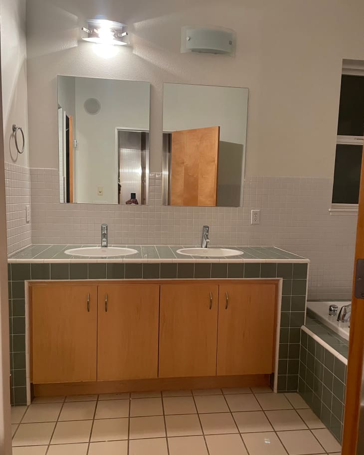 Green tiled bathroom vanity before renovation.