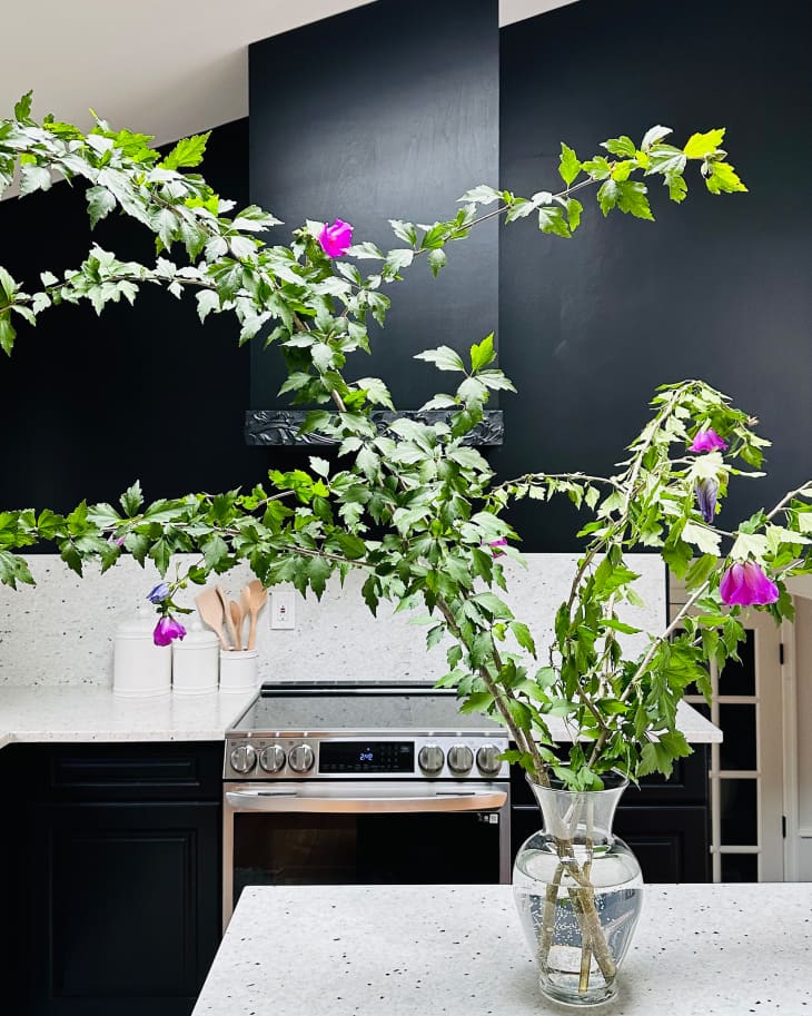 Floral arrangement on island in center of newly renovated kitchen.