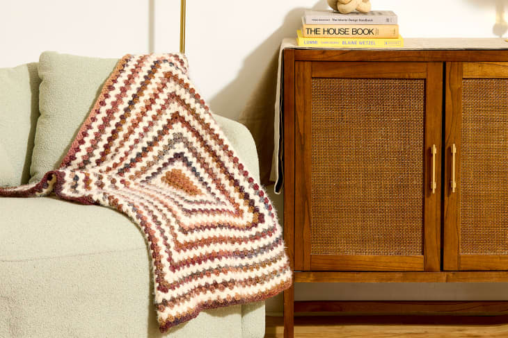living room sofa with crocheted blanket
