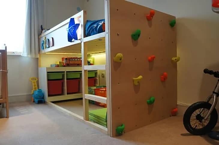 Climbing wall installed on the side of a bunk bed.