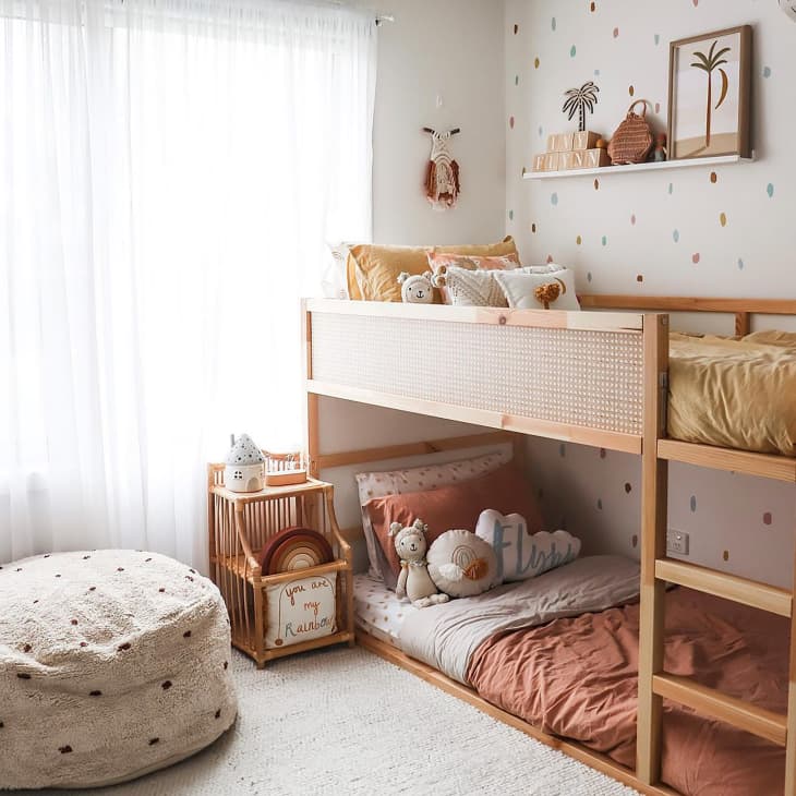 Wooden bunk bed with wood caning in kids room.
