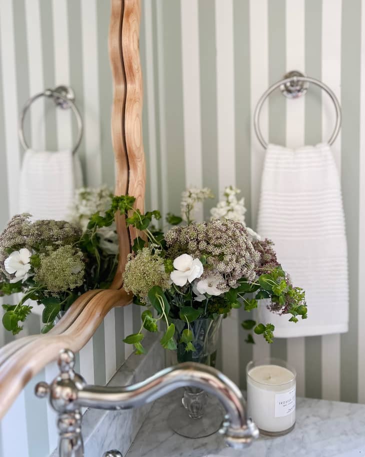Floral arrangement on bathroom vanity in newly remodeled bathroom.