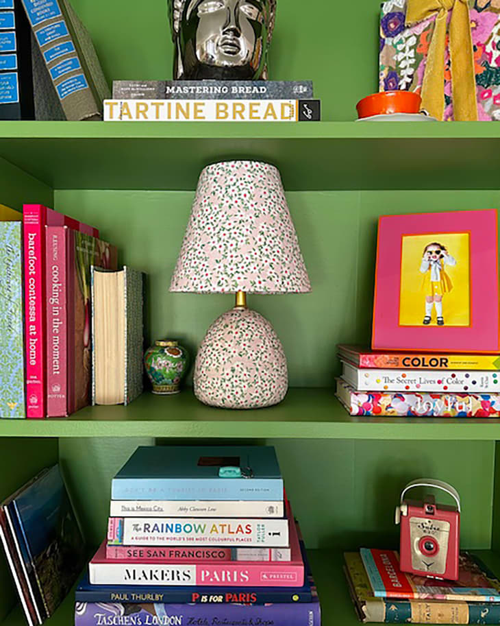 Hand painted lamp on bookshelf.