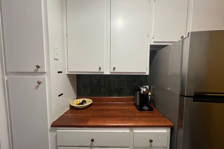 Peel and stick kitchen decor with green tile and butcher block.