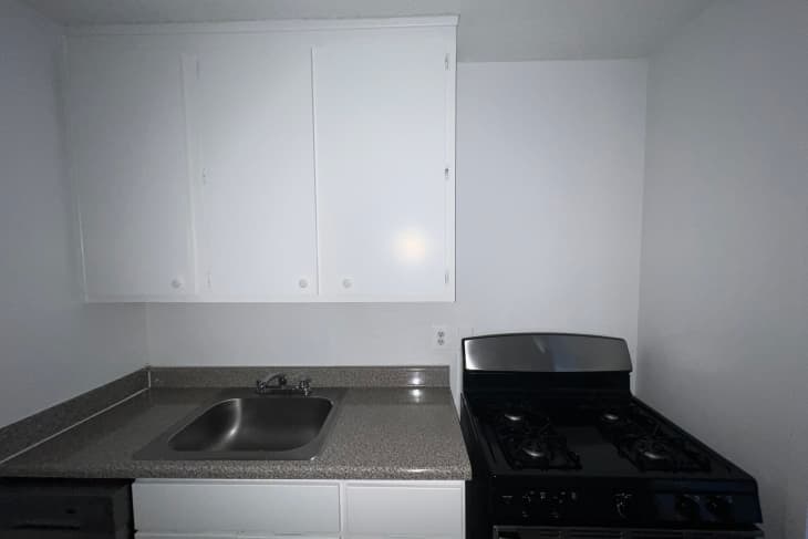 Kitchen with white walls before renovation.