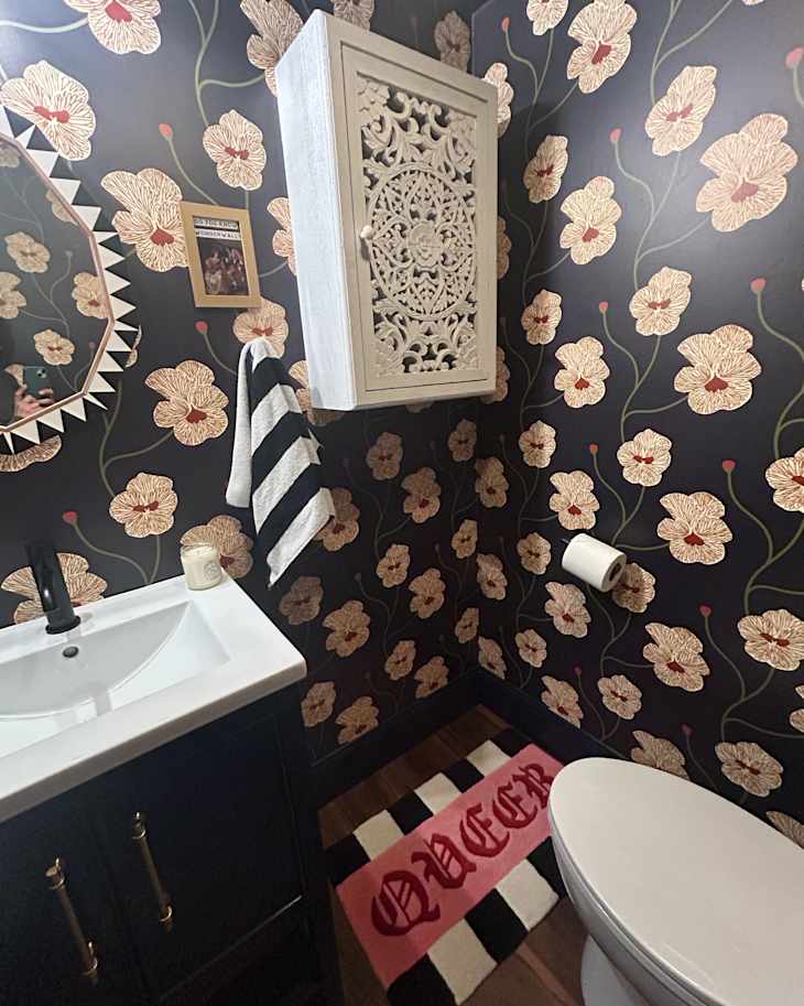 Floral pattern wallpaper in black bathroom after project