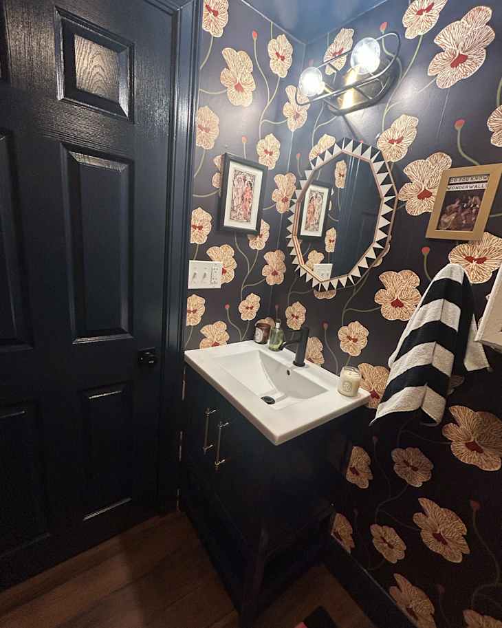 Floral pattern wallpaper in black bathroom after project