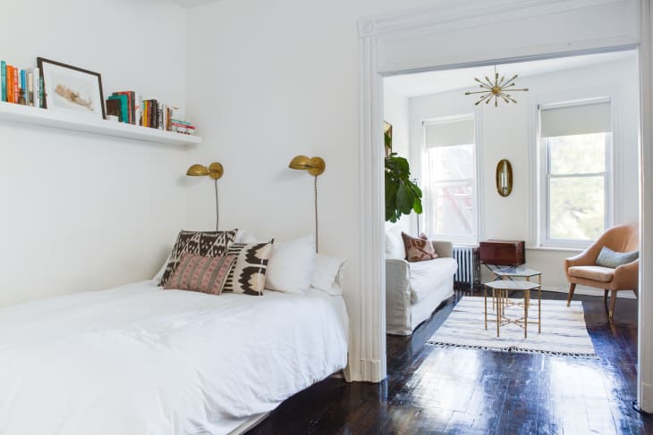 bedroom with small sitting area and shelf