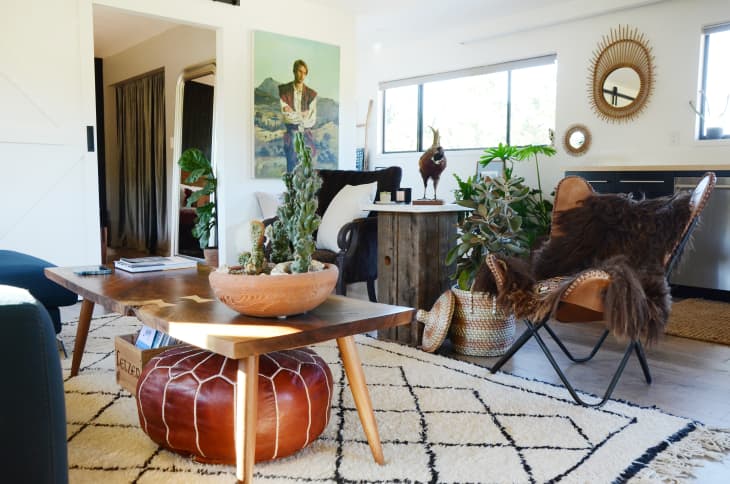 Small living room with a leather pouf stored under the coffee table