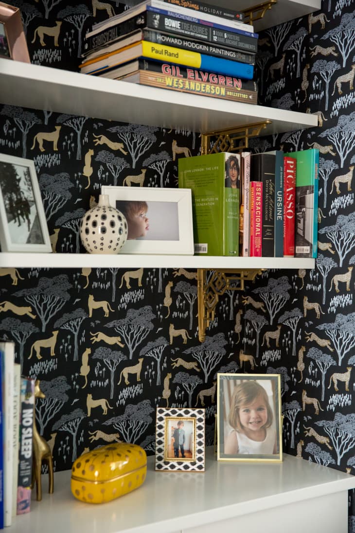 Wallpaper behind a bookshelf.