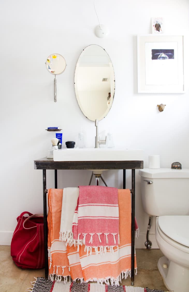 Have a tile wall bathroom? Use a corner shelf to store your towels and  toiletries. Fold your towels like…