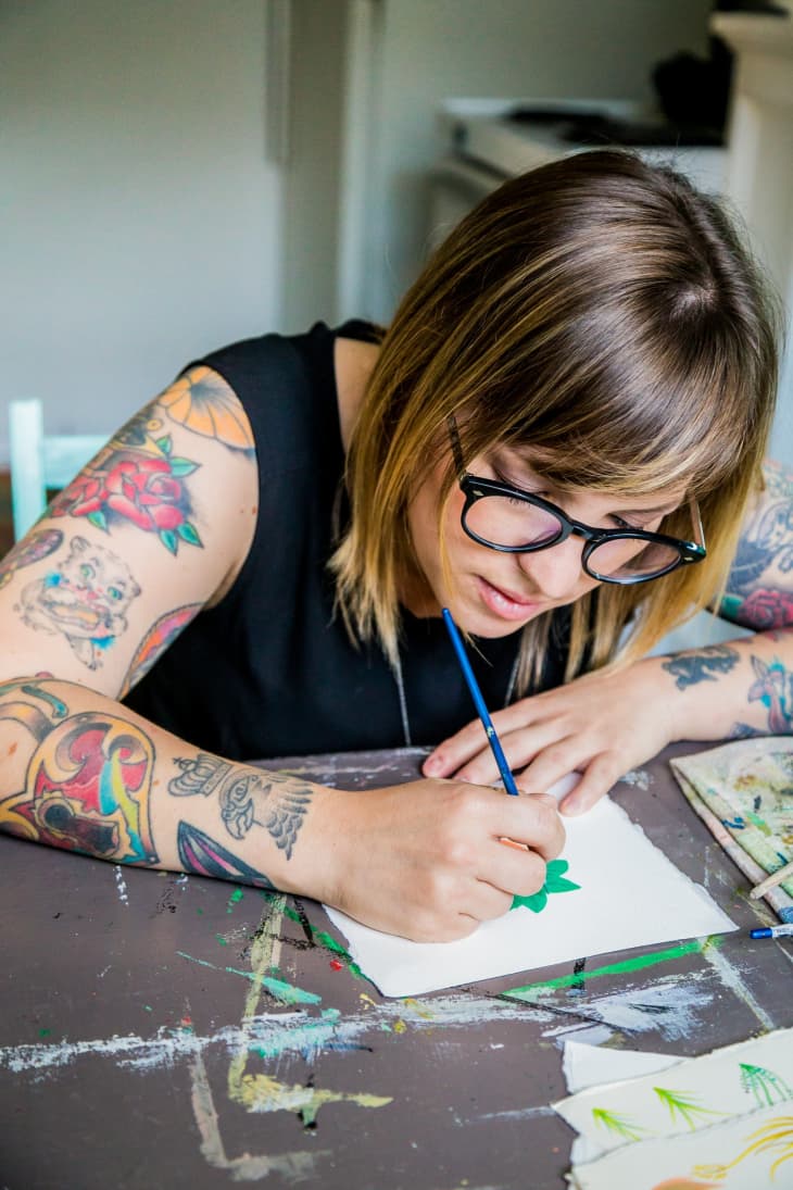 An artist drawing on a piece of paper