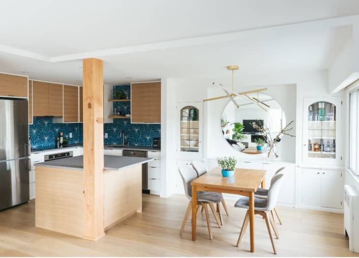 An open Scandi-inspired kitchen with wood accents and white walls