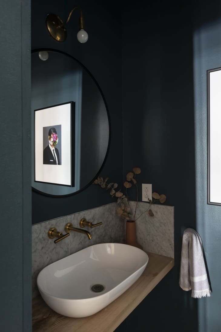 Half bath with large oval sink and marble backsplash