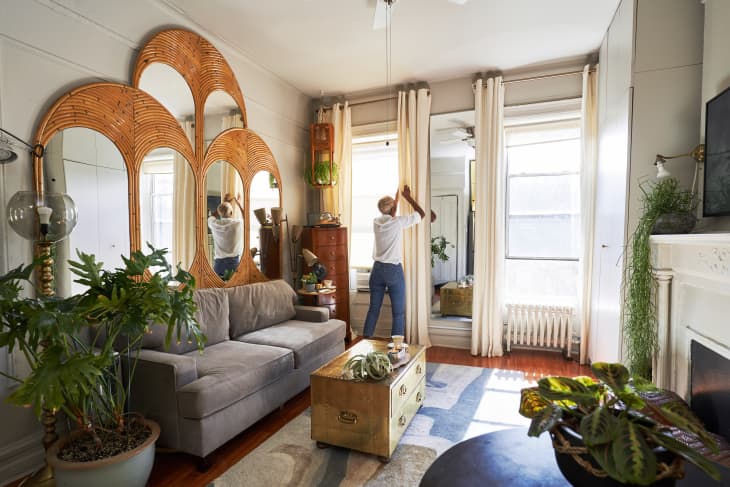 Light-filled living room with curved mirrors set in bamboo frames