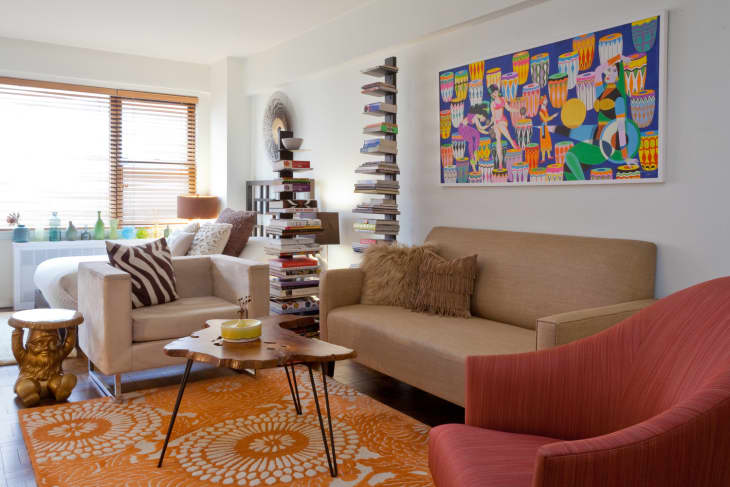Orange rug in a colorful studio apartment living room