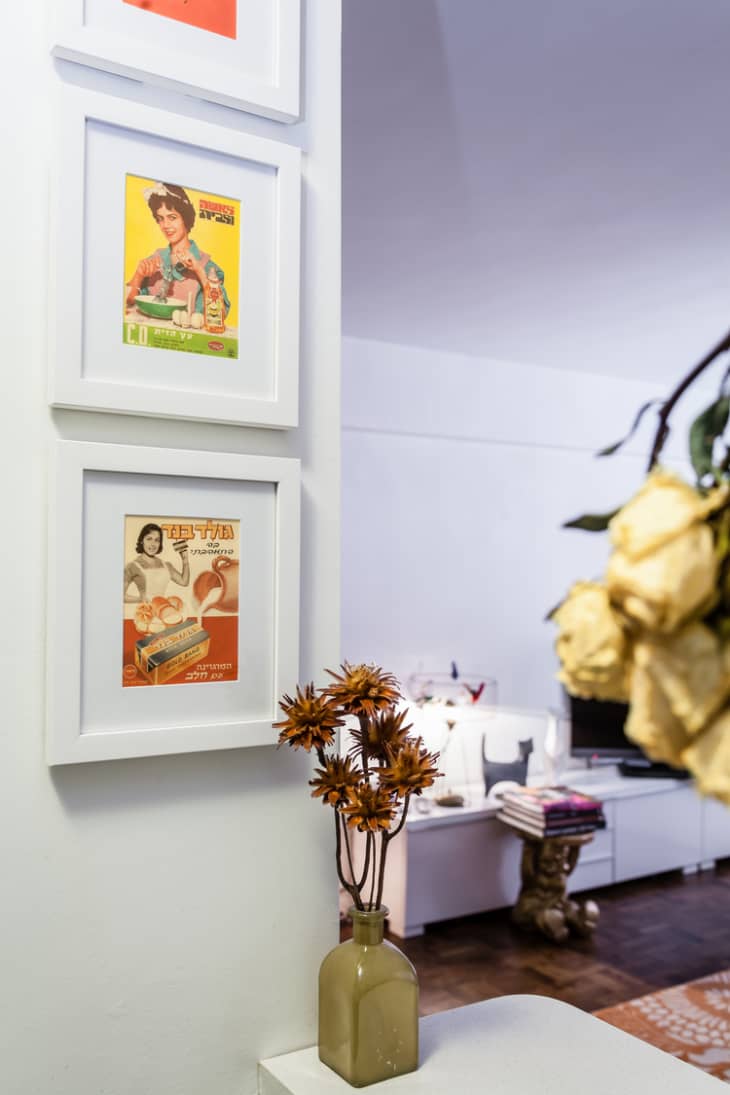 Vintage art prints in white frames hanging on a wall