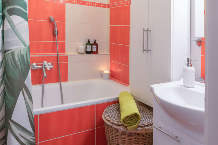 Bathtub with bright coral tile