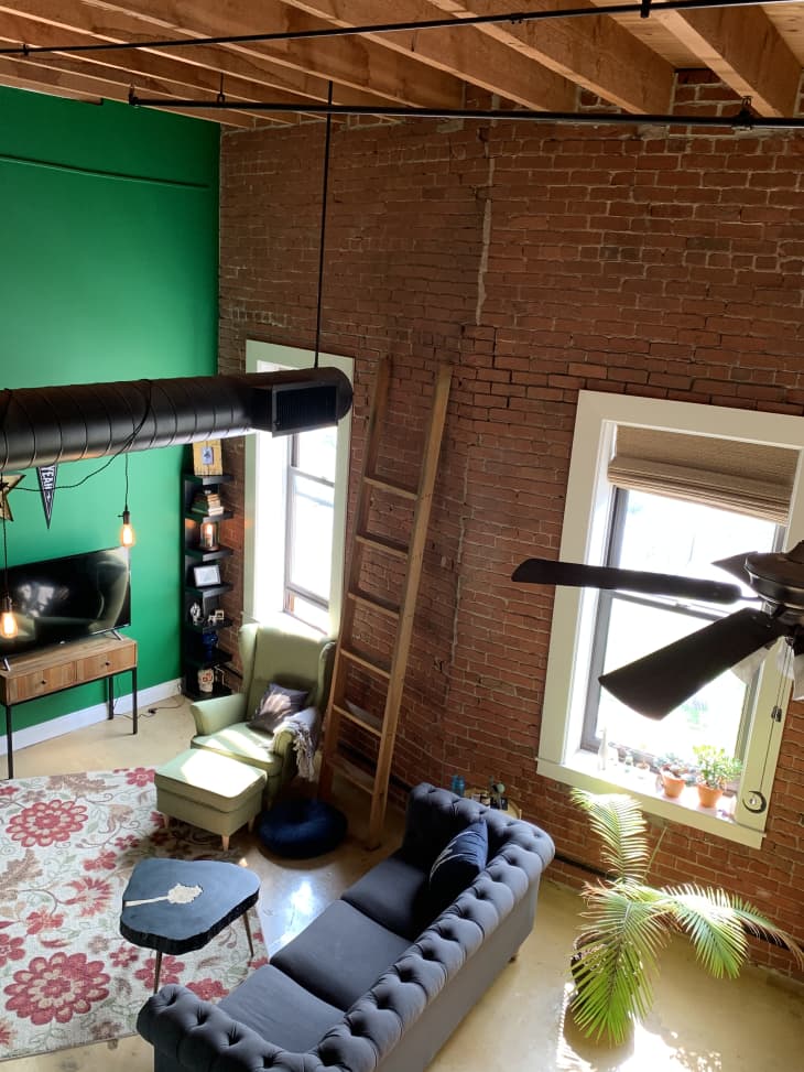 Birds-eye view of industrial loft with green walls and exposed brick