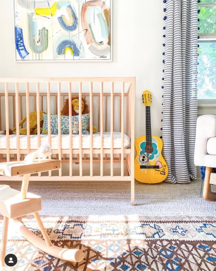 Nursery with guitar next to crib