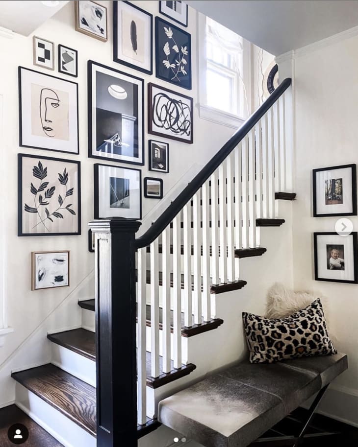 Stairway with black and white art gallery wall