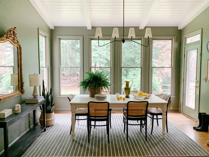 Dining room with sage walls and large windows