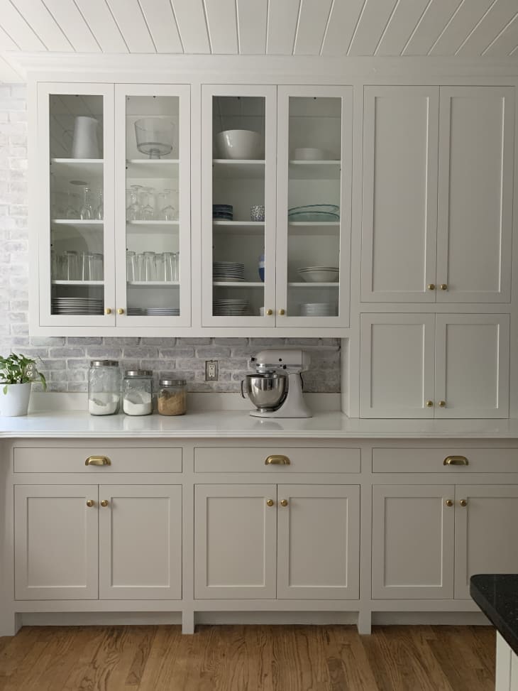 White cabinetry and backsplash in kitchen