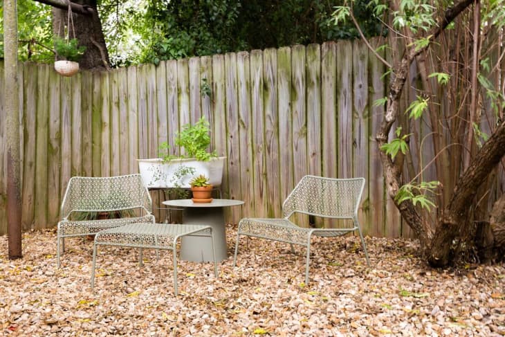 Outdoor sitting area in front of a fence