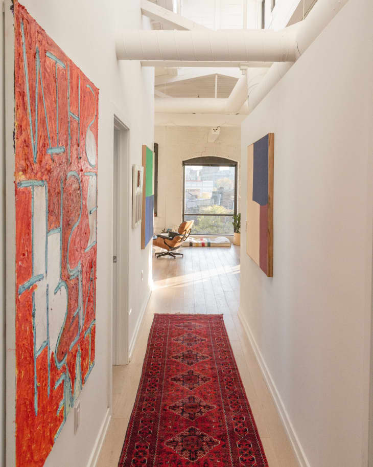 Hallway with red artwork and red runner