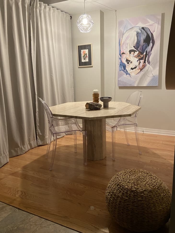Dining area with skull artwork and clear lucite chairs
