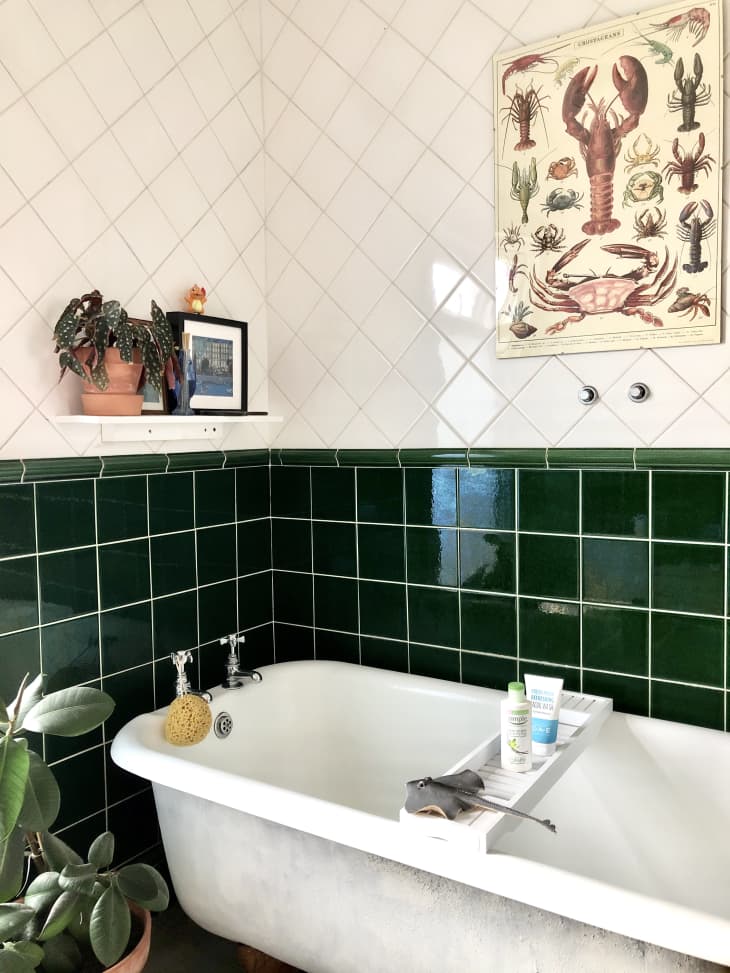 Bathroom with green tile and white tub