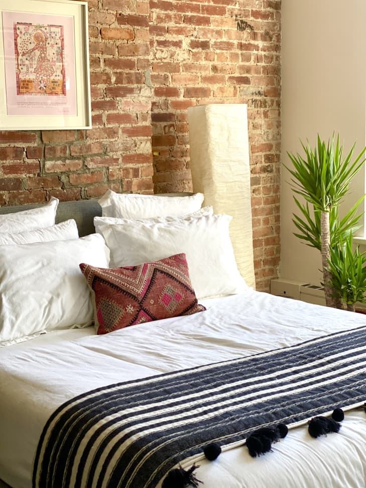 Boho bedroom with exposed brick wall