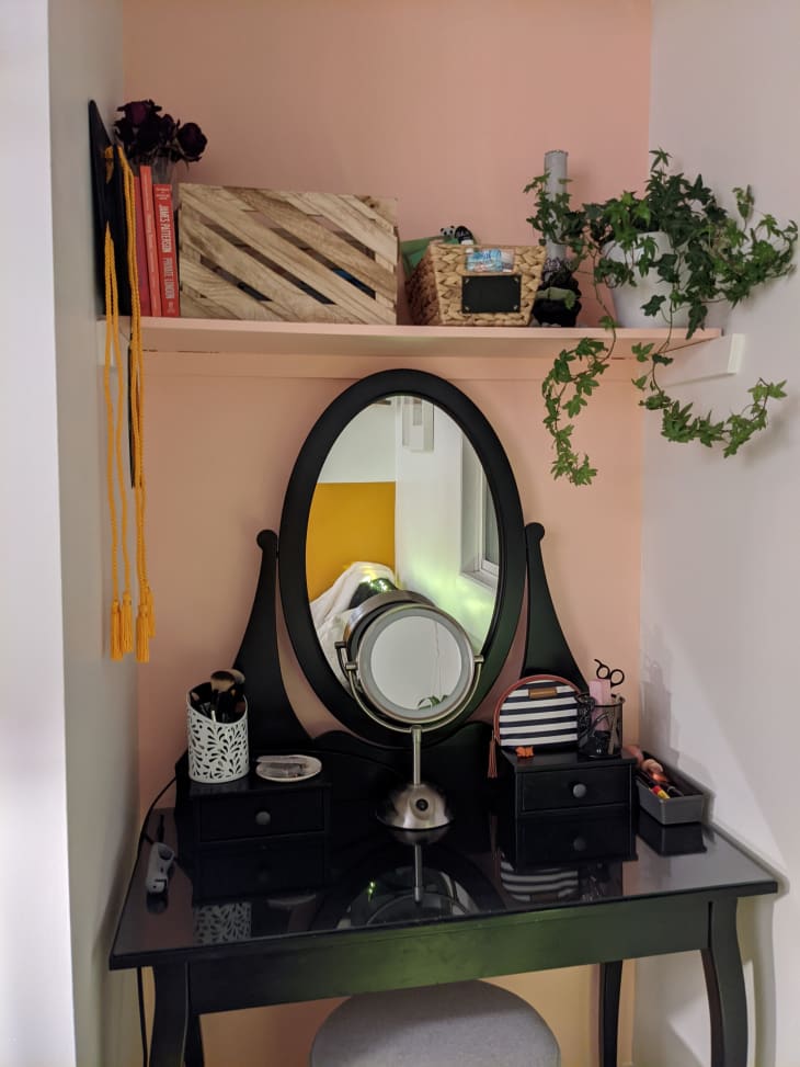 Vanity with shelf above in front of wall painted blush pink