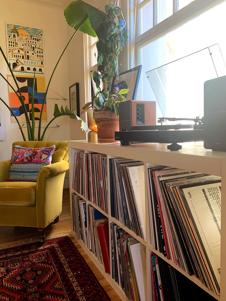 Shelf with records and record player next to window